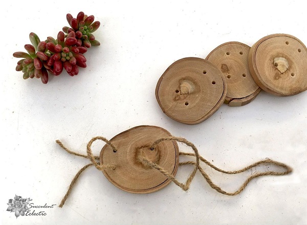 adding jute hangers to wood slice Christmas ornaments
